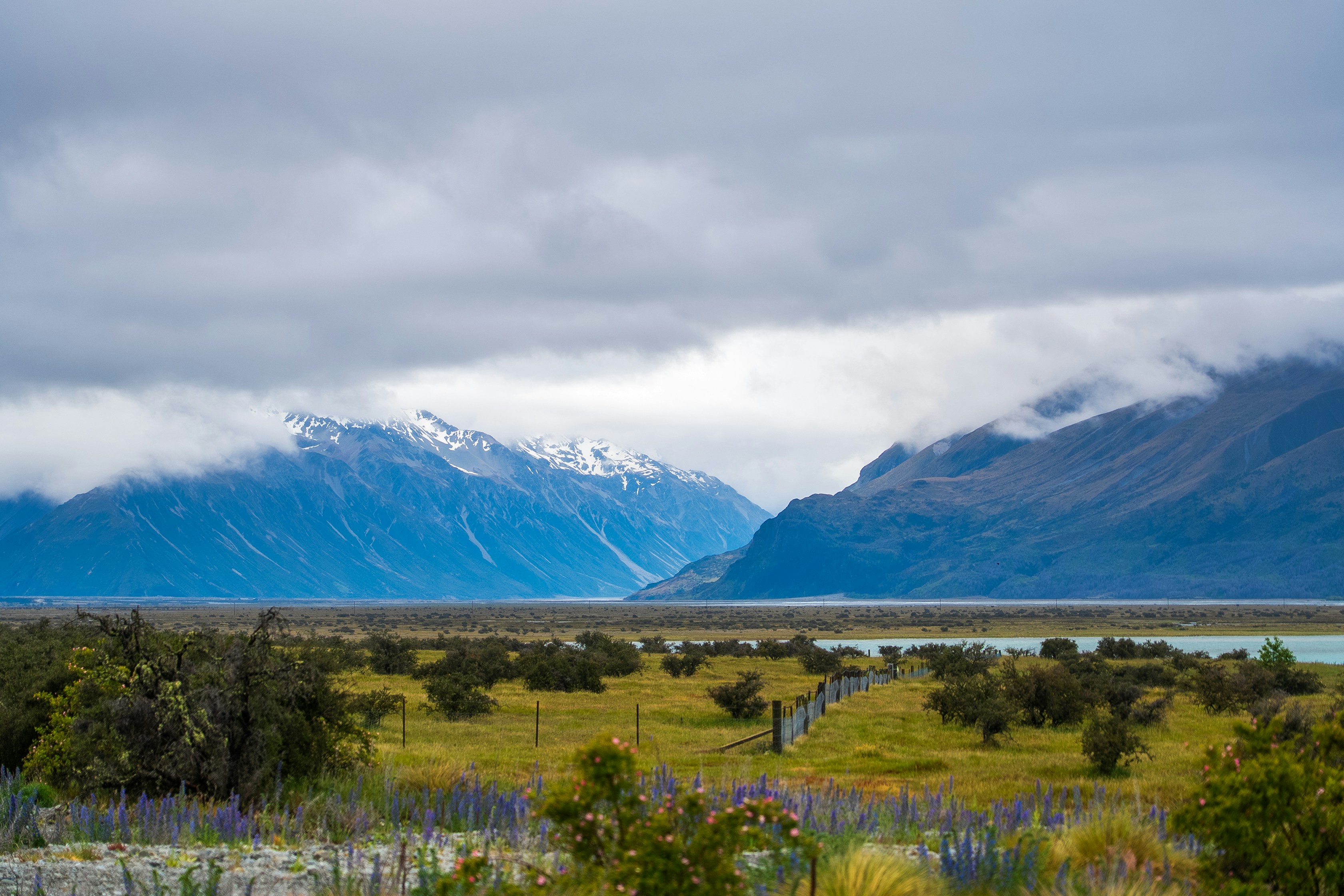 Clouds over fenced countryside near Glentanner, New Zealand.